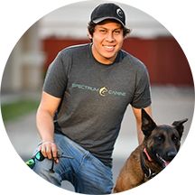Spectrum Canine trainer beside a dog