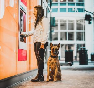 Woman and dog outside a storefront